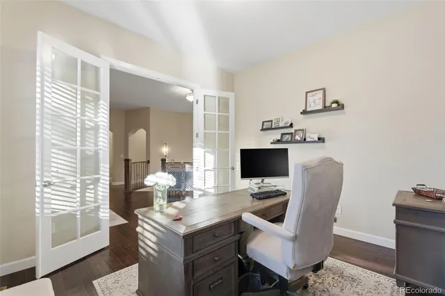a view of a workspace with furniture and a window
