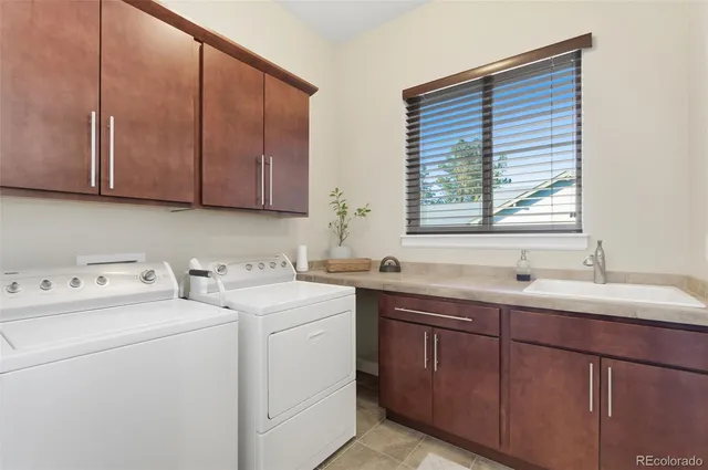 a view of a kitchen with sink and washer dryer