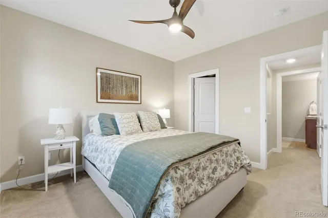 a bedroom with a bed and a painting on the wall