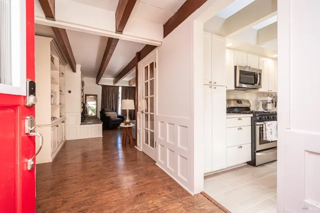 a view of a hallway view with furniture and wooden floor