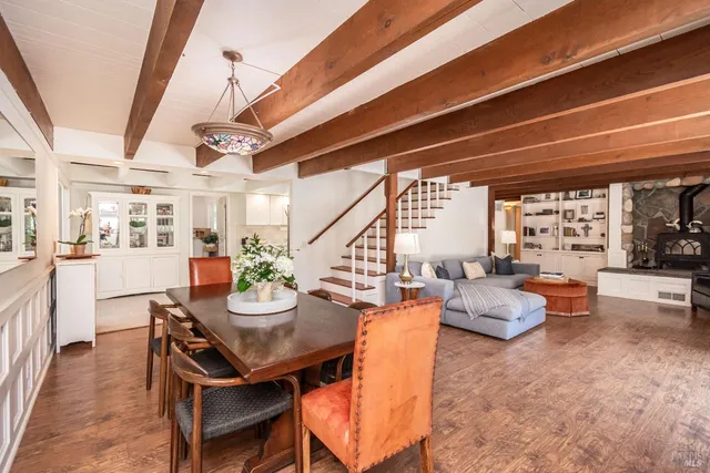 a outdoor dining room with furniture and a large window