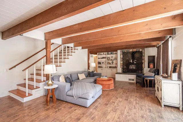 a living room with furniture and a floor to ceiling window