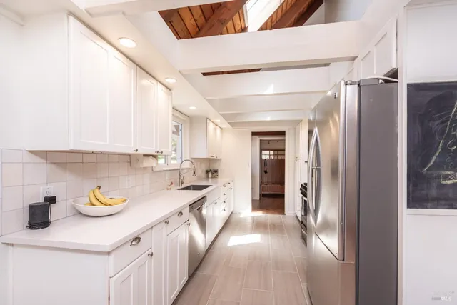 a kitchen with refrigerator and cabinets