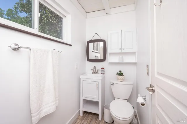 a white toilet sitting next to a bathroom sink