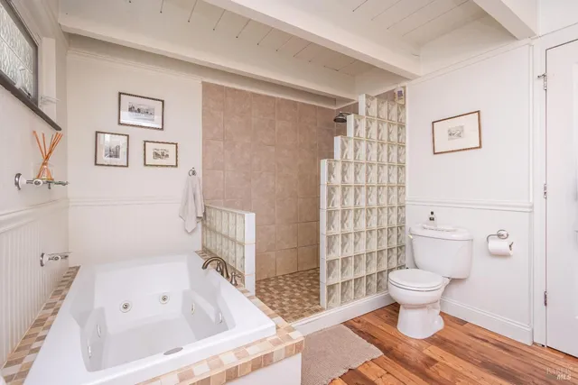 a bathroom with a toilet and a shower