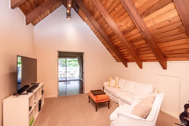 a living room with furniture a flat screen tv and a window
