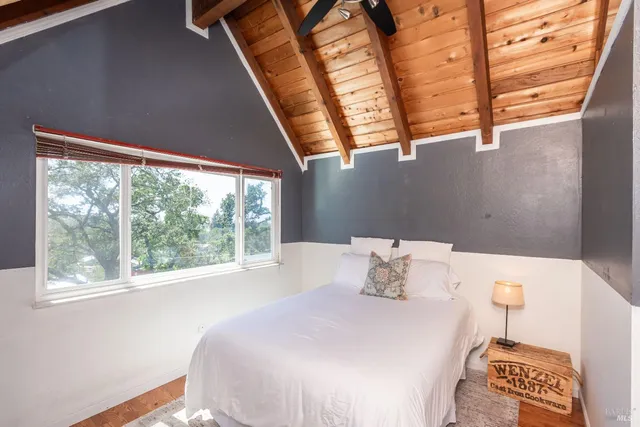 a bedroom with a bed and a window