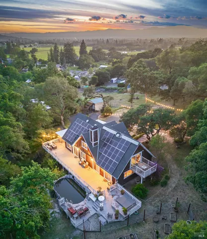 an aerial view of a house with a lake view