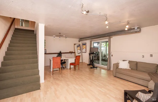 a living room with furniture and wooden floor