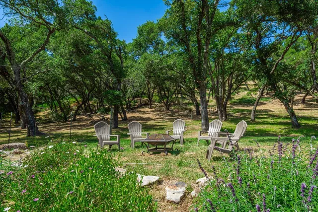 a backyard of a house with table and chairs