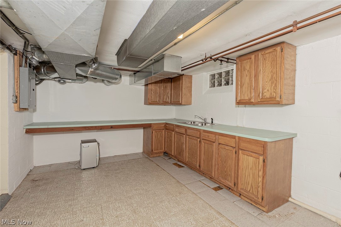 28430 Edgedale Road Pepper Pike, OH 44124 - Photo 22 of 35 Service area for entertaining in the lower level, cabinets for storage with a sink.
