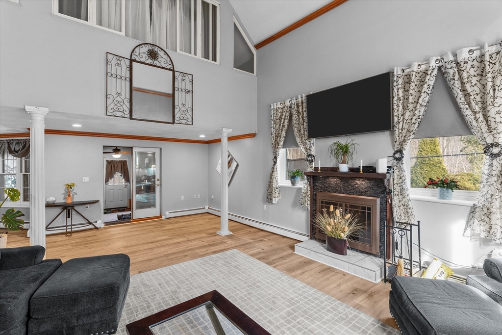 85 Folly Mill Road Salisbury, MA 01952 - Photo 6 of 40 a living room with furniture a flat screen tv and a fireplace