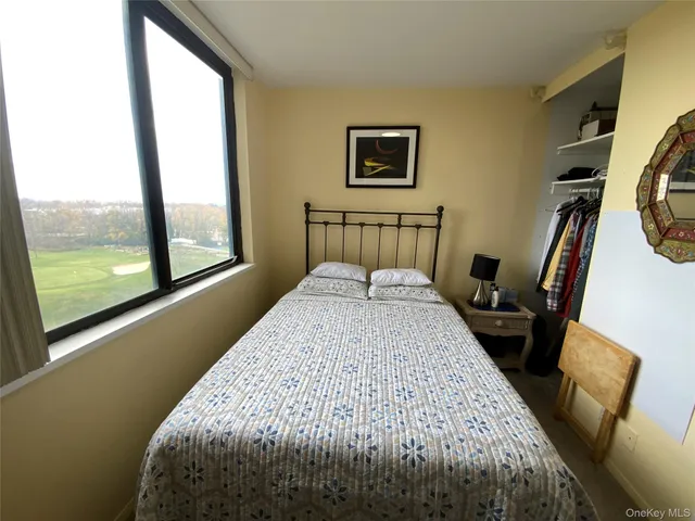 a bed sitting in a bedroom next to a window