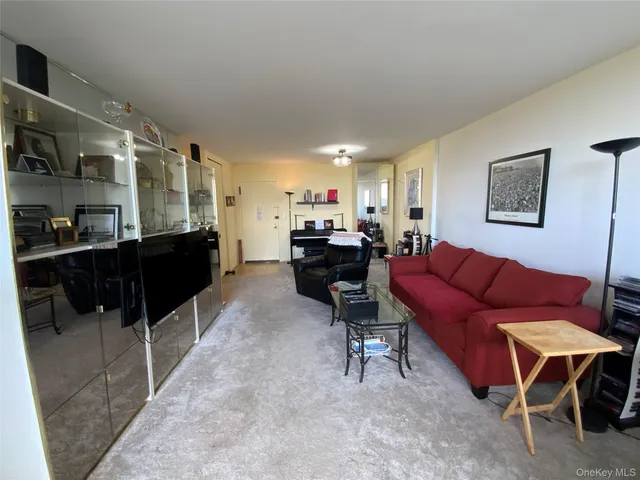 a living room with furniture and a piano
