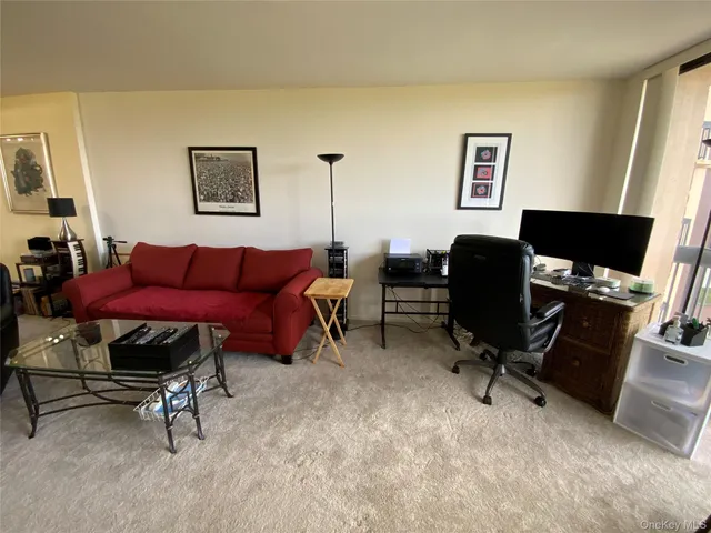 a view of a livingroom with workspace and a couch