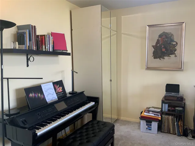 a living room with furniture and a piano