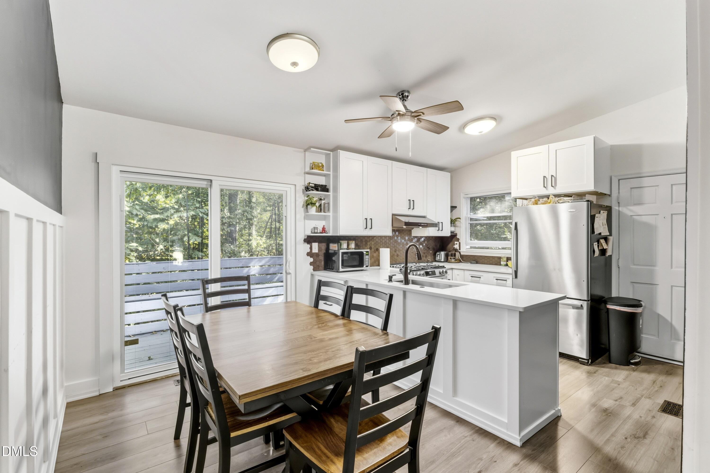 6125 Bellow Street Raleigh, NC 27609 - Photo 10 of 41 a view of a dining room with furniture window and wooden floor