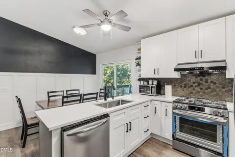 a kitchen with a stove a sink and a refrigerator