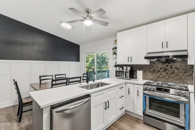 a kitchen with a stove a sink and a refrigerator