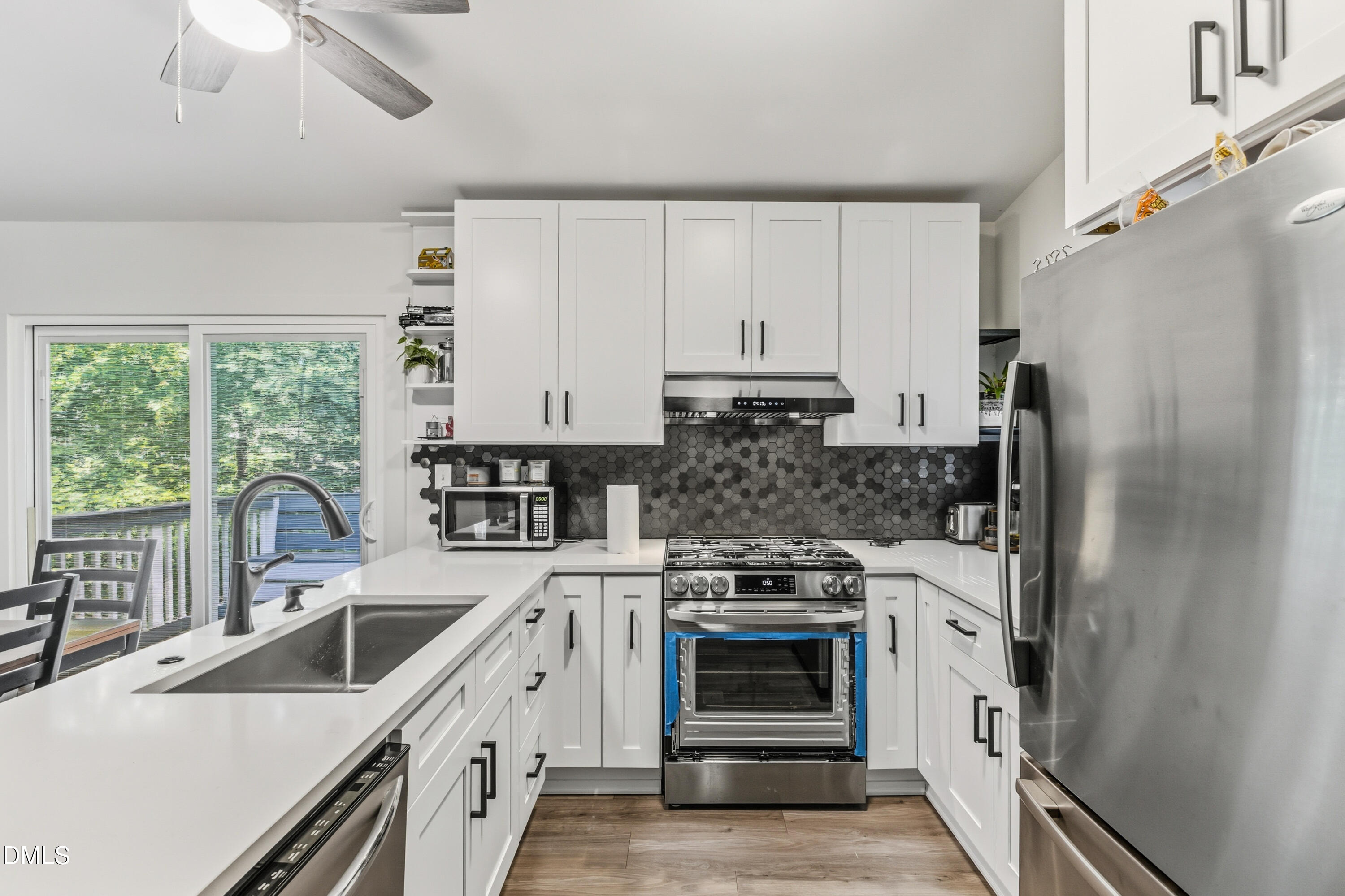 6125 Bellow Street Raleigh, NC 27609 - Photo 13 of 41 a kitchen with stainless steel appliances a stove sink and refrigerator