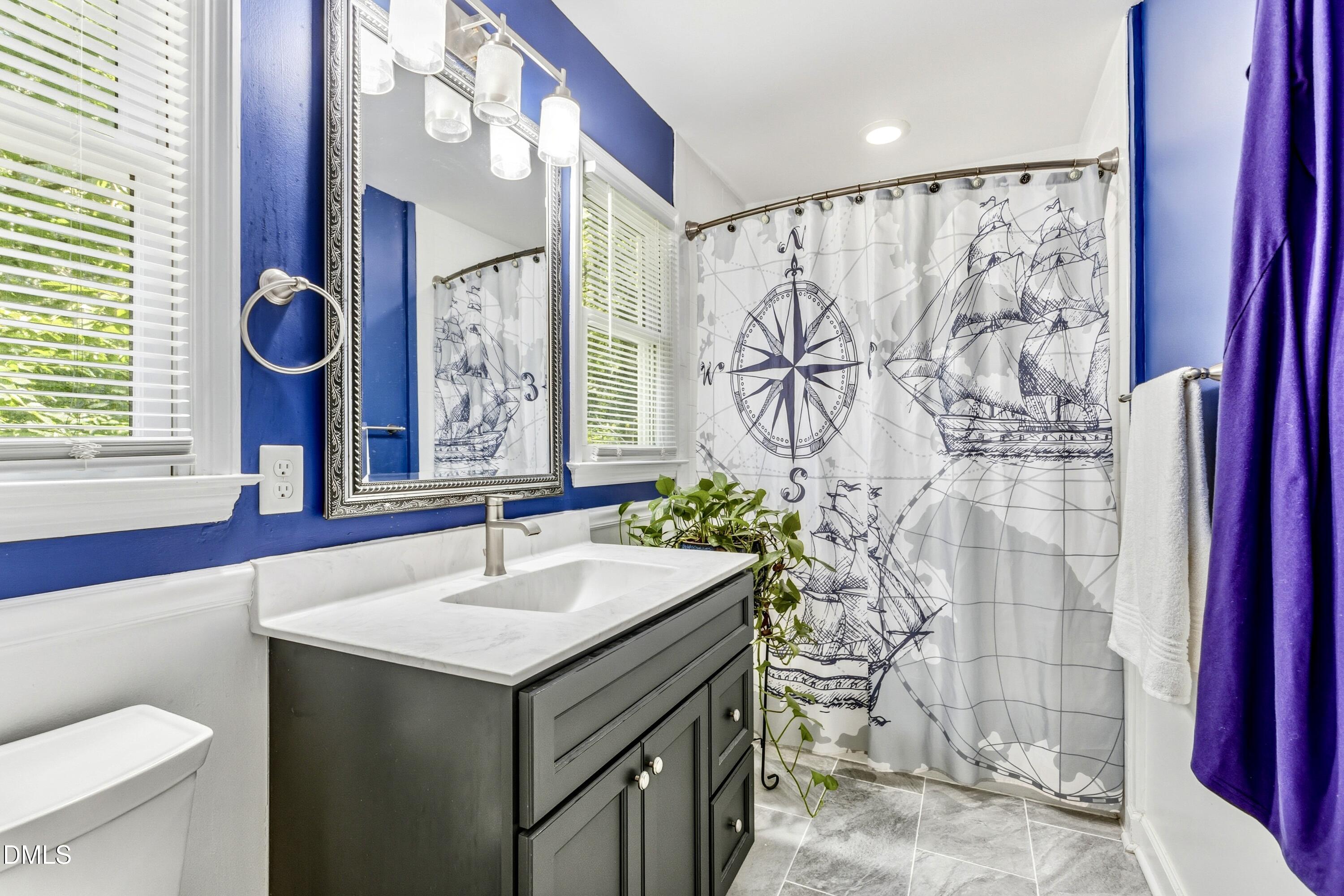 6125 Bellow Street Raleigh, NC 27609 - Photo 17 of 41 a bathroom with a sink and a mirror