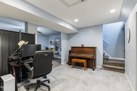 a room with furniture a piano and wooden floor