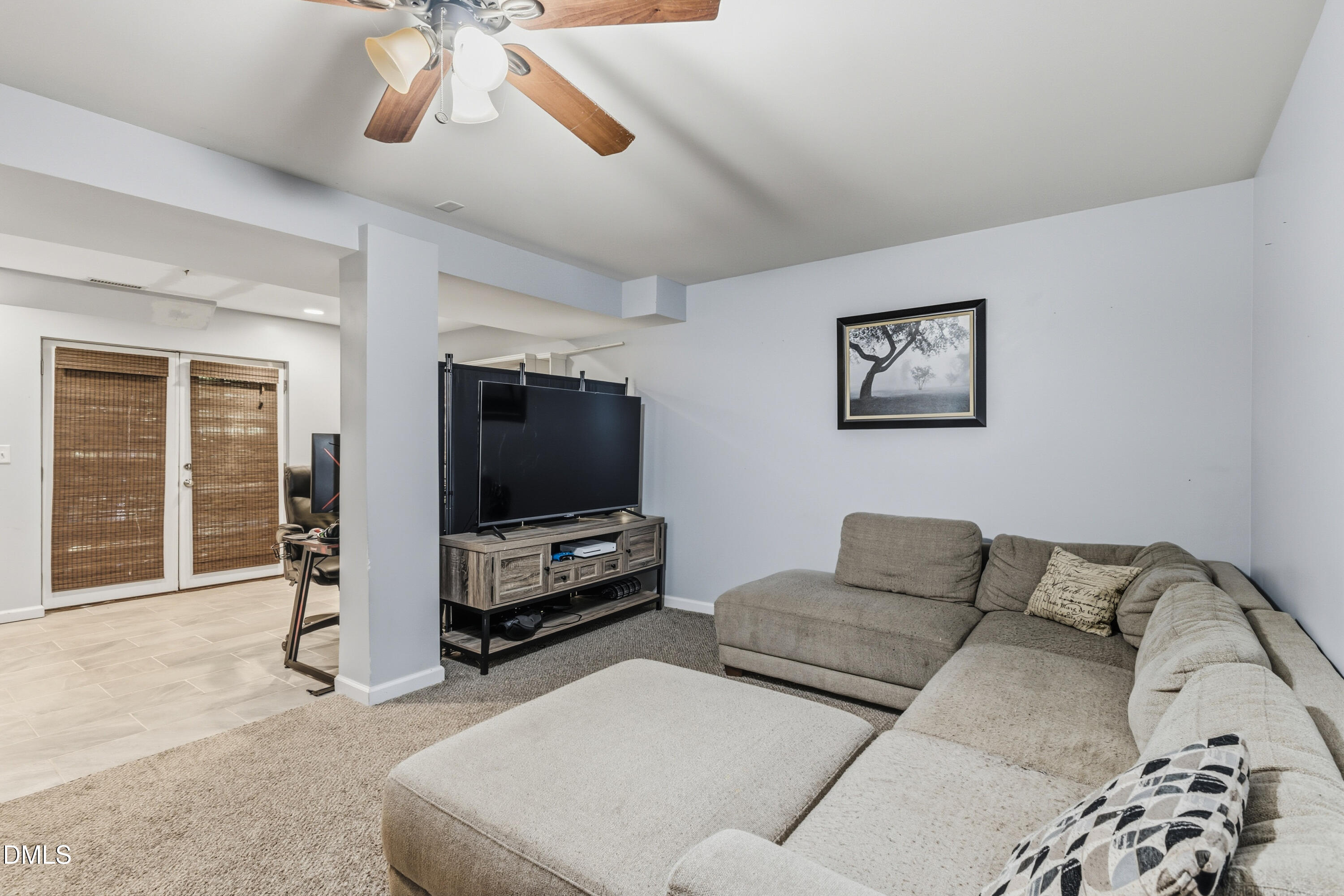 6125 Bellow Street Raleigh, NC 27609 - Photo 25 of 41 a living room with furniture and a flat screen tv