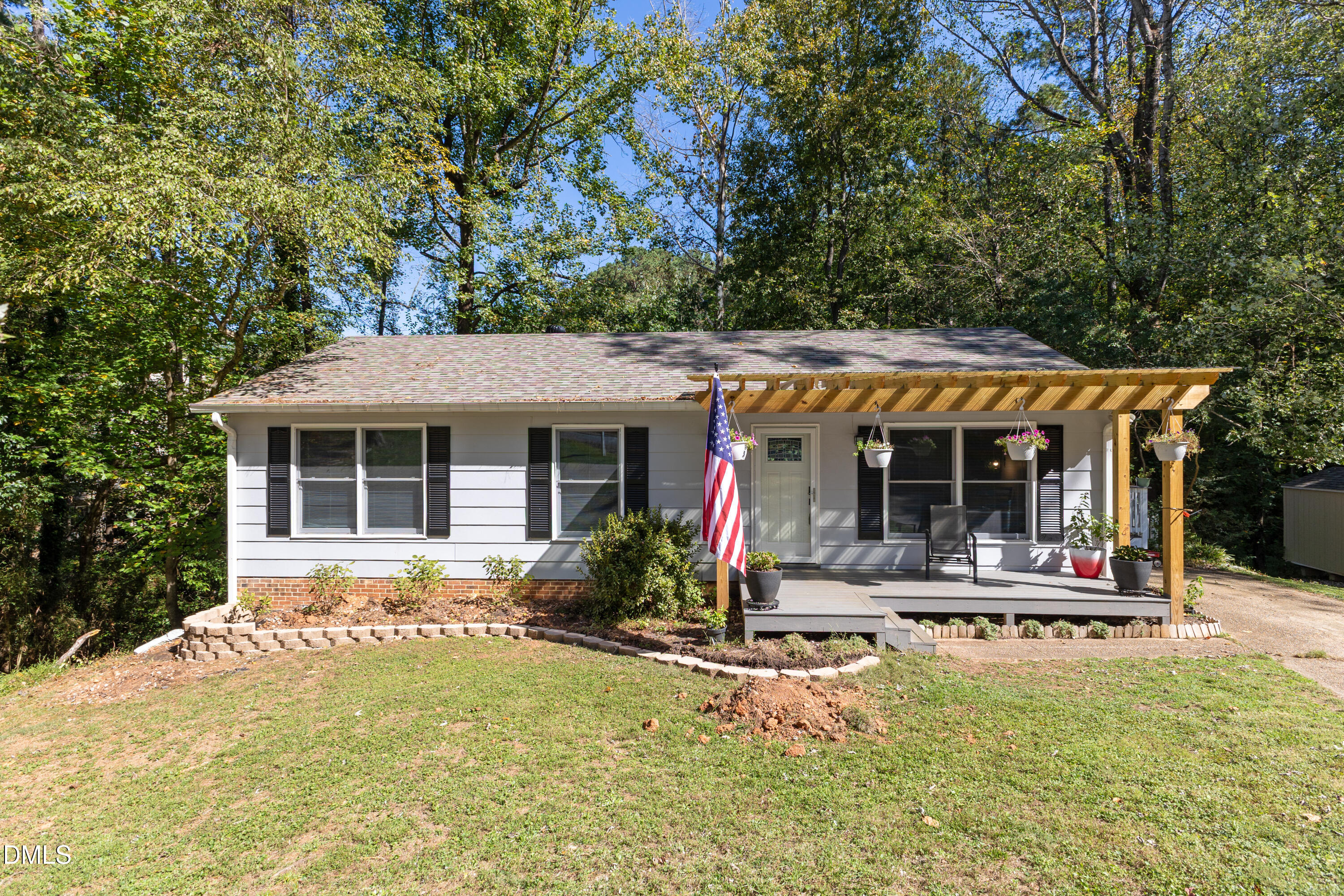 6125 Bellow Street Raleigh, NC 27609 - Photo 2 of 41 a view of a house with floor to ceiling windows and a basket ball poll