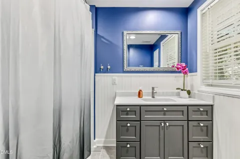 a bathroom with a sink vanity and a mirror