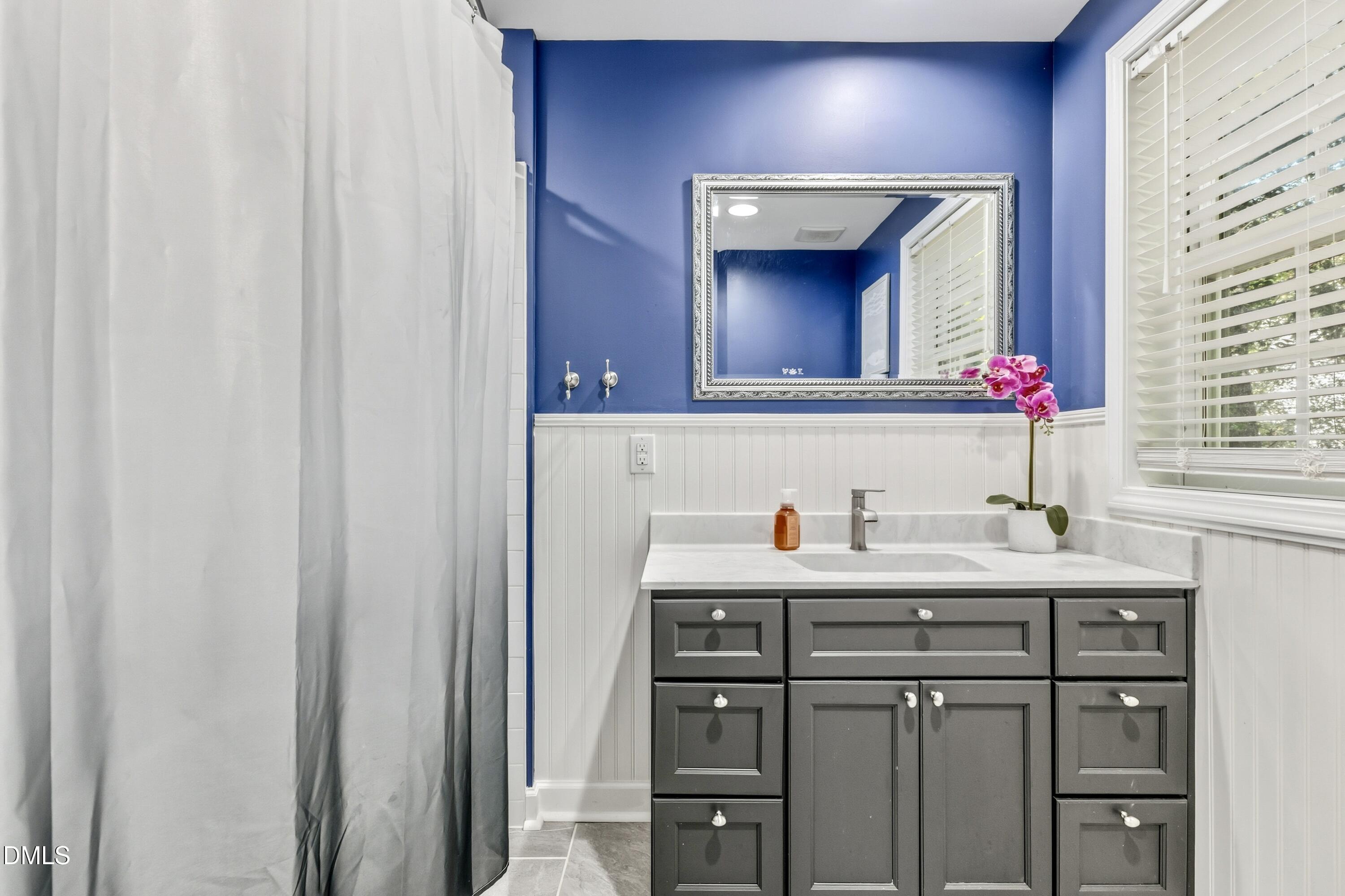 6125 Bellow Street Raleigh, NC 27609 - Photo 30 of 41 a bathroom with a sink vanity and a mirror