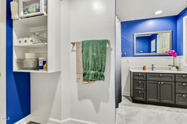 a bathroom with a sink vanity and mirror