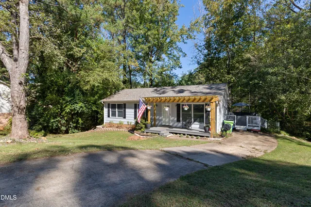 a view of a house with backyard and sitting area