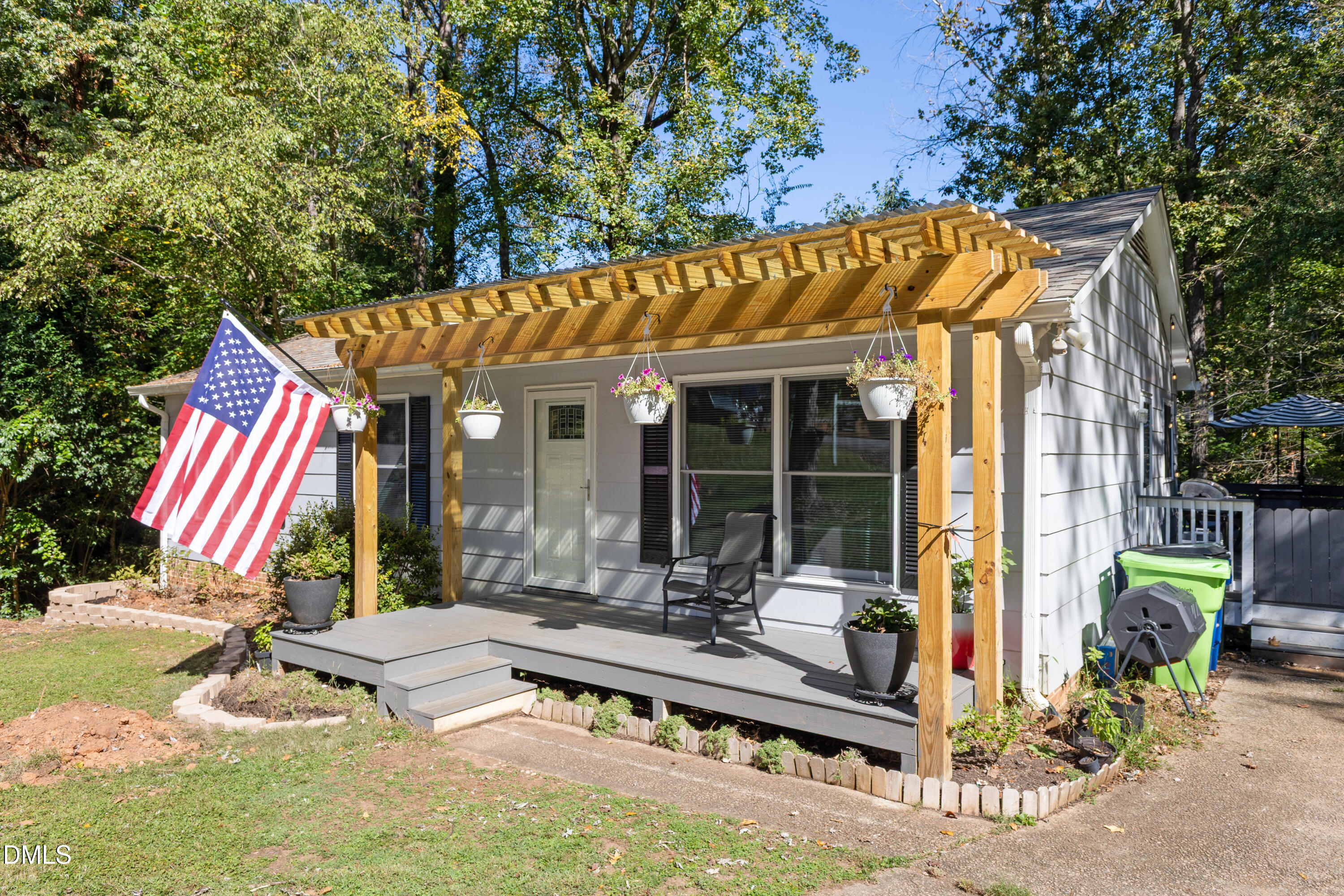6125 Bellow Street Raleigh, NC 27609 - Photo 5 of 41 a view of backyard with a table and chairs under an umbrella