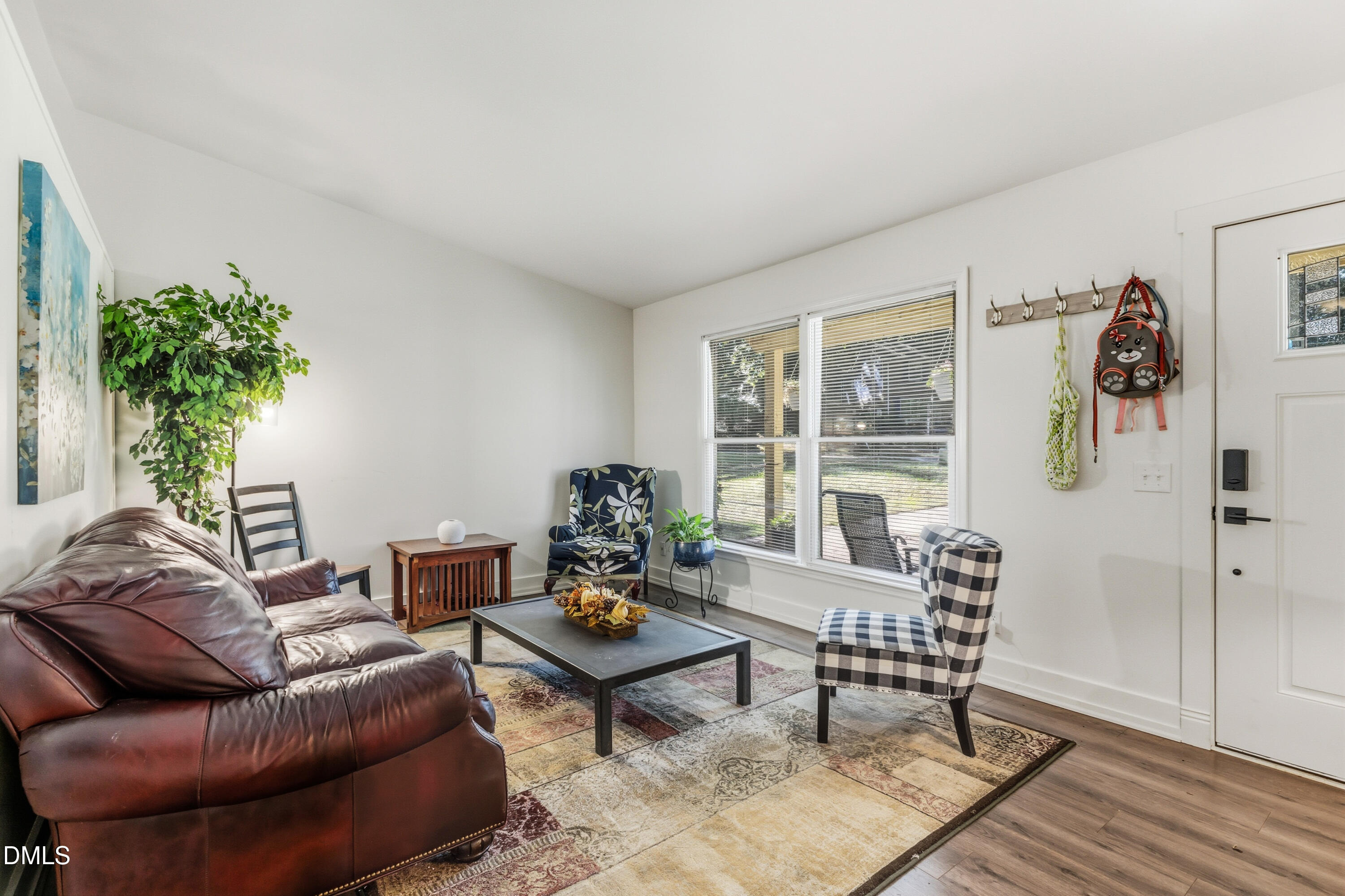 6125 Bellow Street Raleigh, NC 27609 - Photo 7 of 41 a living room with furniture and a potted plant