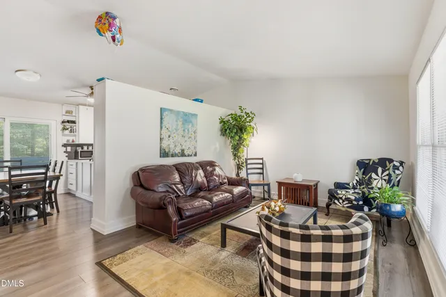 a living room with furniture and a potted plant