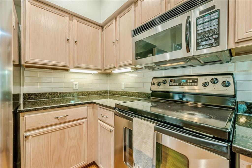 3777 Peachtree Road Northeast, Unit 1632 Brookhaven, GA 30319 - Photo 11 of 43 a kitchen with stainless steel appliances granite countertop a sink stove and cabinets