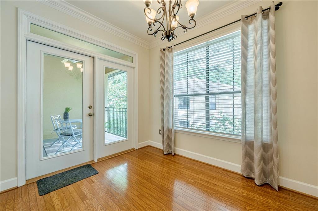 3777 Peachtree Road Northeast, Unit 1632 Brookhaven, GA 30319 - Photo 12 of 43 a view of an empty room with wooden floor and a window