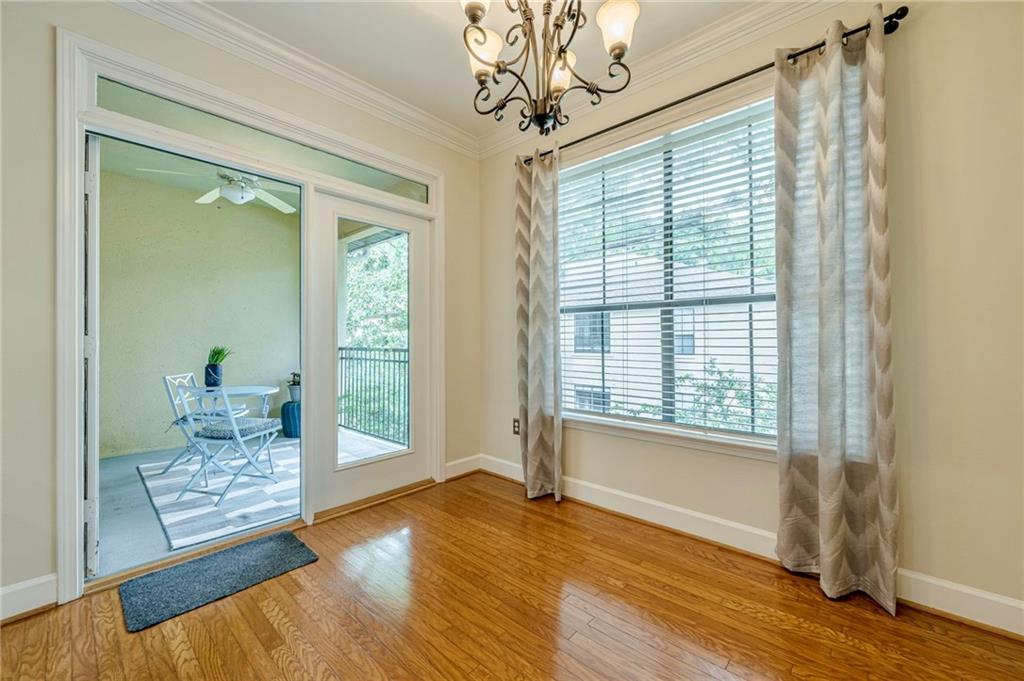 3777 Peachtree Road Northeast, Unit 1632 Brookhaven, GA 30319 - Photo 13 of 43 a view of an empty room with wooden floor and a window