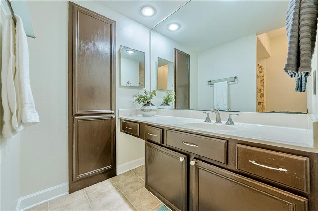 3777 Peachtree Road Northeast, Unit 1632 Brookhaven, GA 30319 - Photo 16 of 43 a bathroom with a sink and a mirror