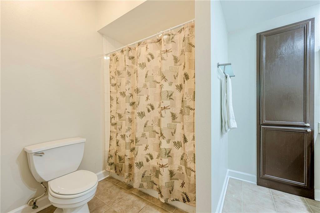 3777 Peachtree Road Northeast, Unit 1632 Brookhaven, GA 30319 - Photo 17 of 43 a white toilet sitting next to a shower curtain