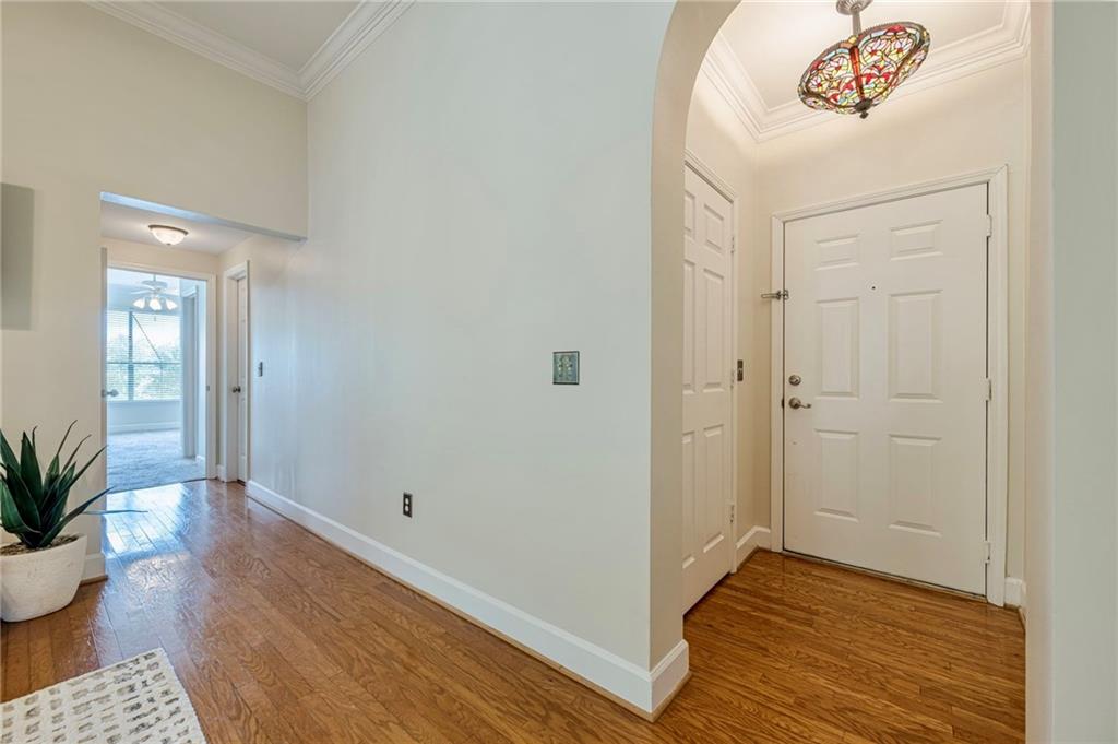3777 Peachtree Road Northeast, Unit 1632 Brookhaven, GA 30319 - Photo 18 of 43 a view of a hallway with wooden floor and a potted plant