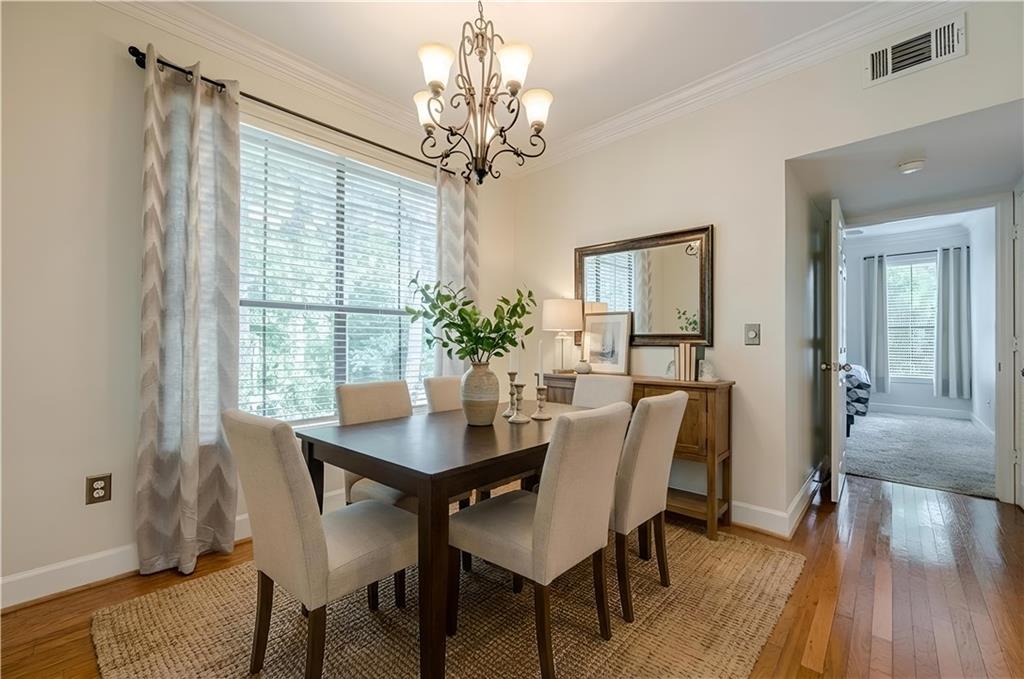 3777 Peachtree Road Northeast, Unit 1632 Brookhaven, GA 30319 - Photo 2 of 43 a view of a dining room with furniture window and wooden floor