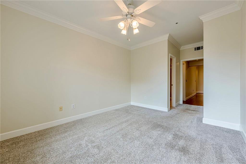 3777 Peachtree Road Northeast, Unit 1632 Brookhaven, GA 30319 - Photo 22 of 43 an empty room with a ceiling fan and a window