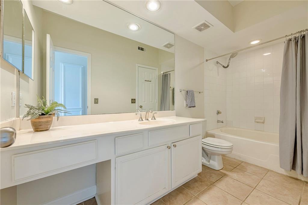 3777 Peachtree Road Northeast, Unit 1632 Brookhaven, GA 30319 - Photo 23 of 43 a bathroom with a double vanity sink toilet mirror and bathtub