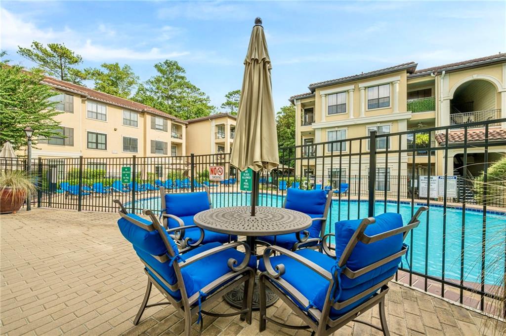 3777 Peachtree Road Northeast, Unit 1632 Brookhaven, GA 30319 - Photo 26 of 43 a view of a patio with a table and chairs