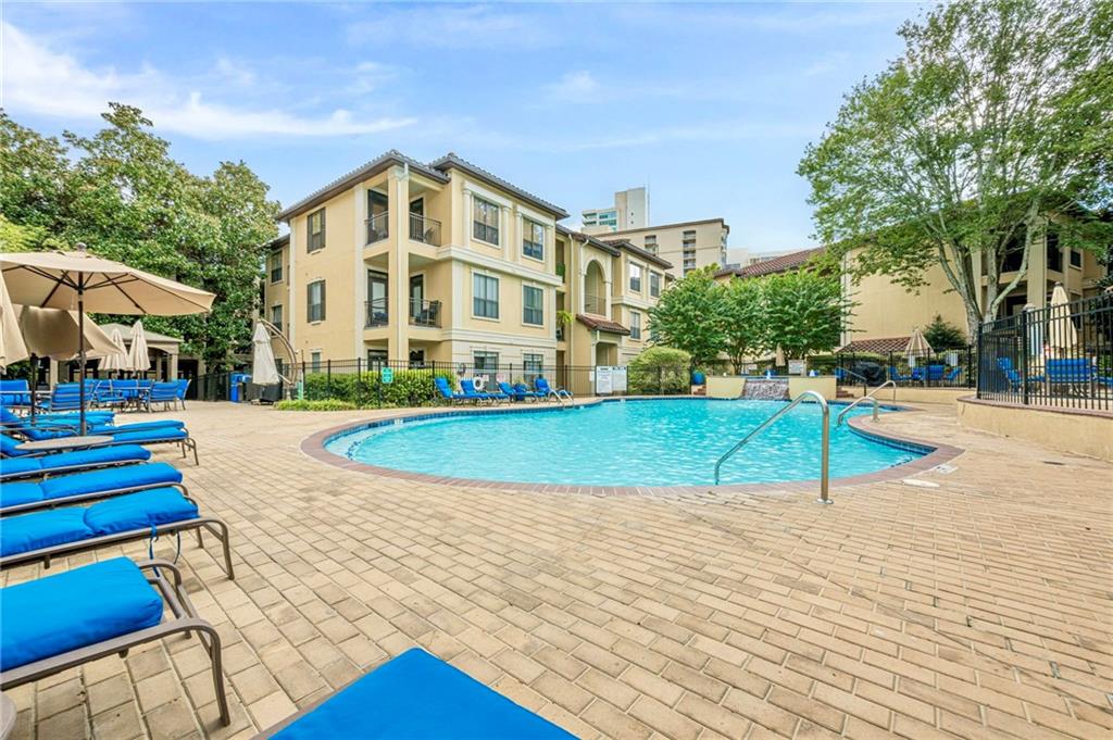 3777 Peachtree Road Northeast, Unit 1632 Brookhaven, GA 30319 - Photo 27 of 43 a view of a swimming pool with a bench