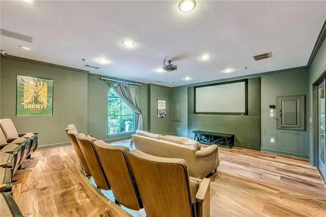 a living room with furniture floor to ceiling window and wooden floor