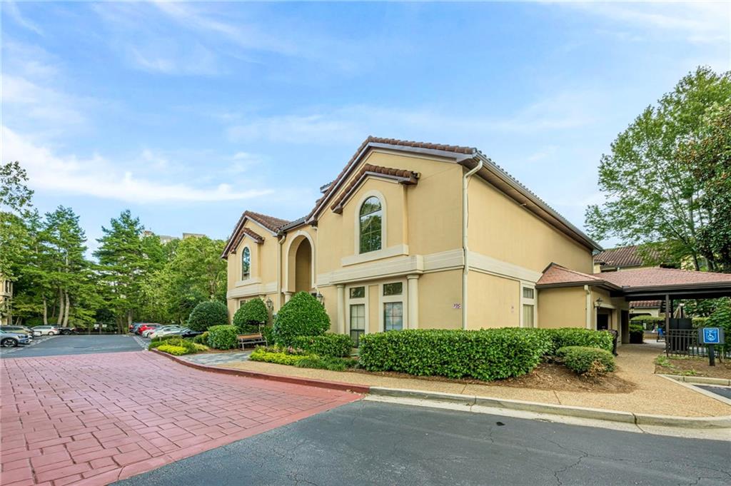 3777 Peachtree Road Northeast, Unit 1632 Brookhaven, GA 30319 - Photo 41 of 43 a front view of a house with a yard