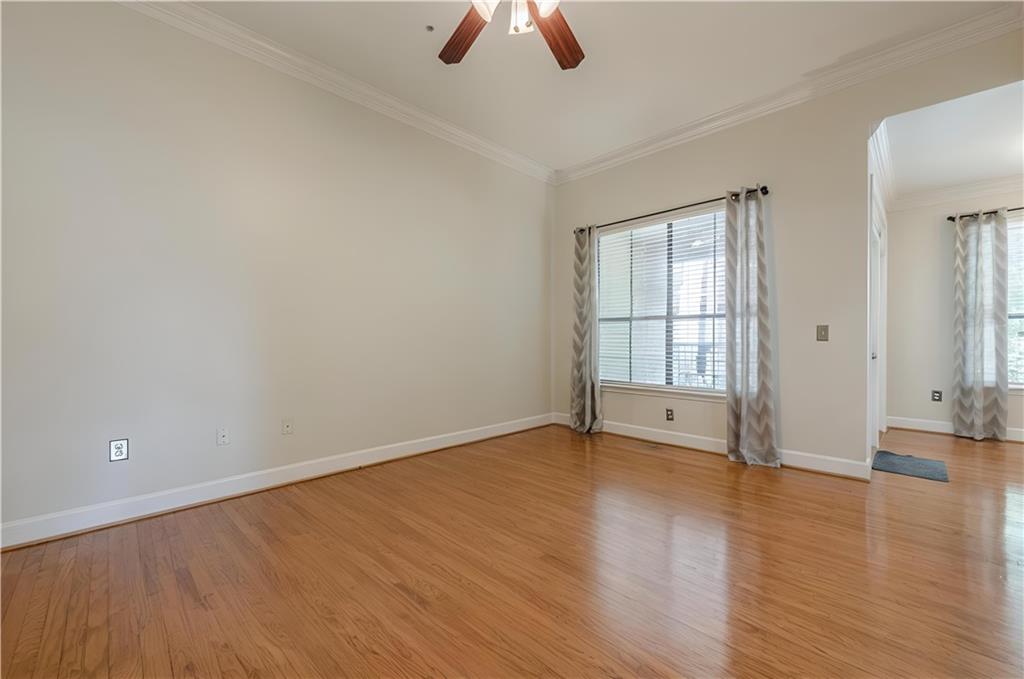 3777 Peachtree Road Northeast, Unit 1632 Brookhaven, GA 30319 - Photo 7 of 43 wooden floor in an empty room with a window