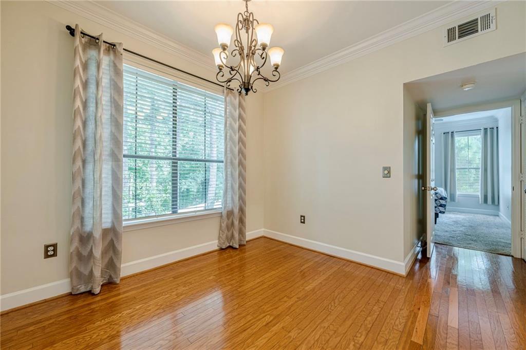 3777 Peachtree Road Northeast, Unit 1632 Brookhaven, GA 30319 - Photo 8 of 43 wooden floor in an empty room with a window